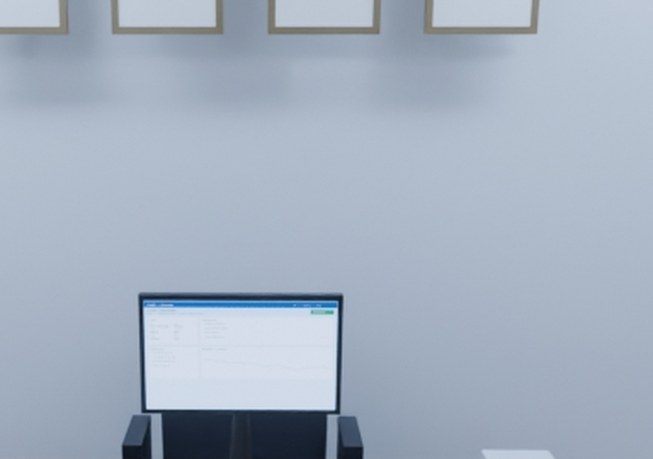Cropped detail: the EMR workstation monitor showing a patient chart.