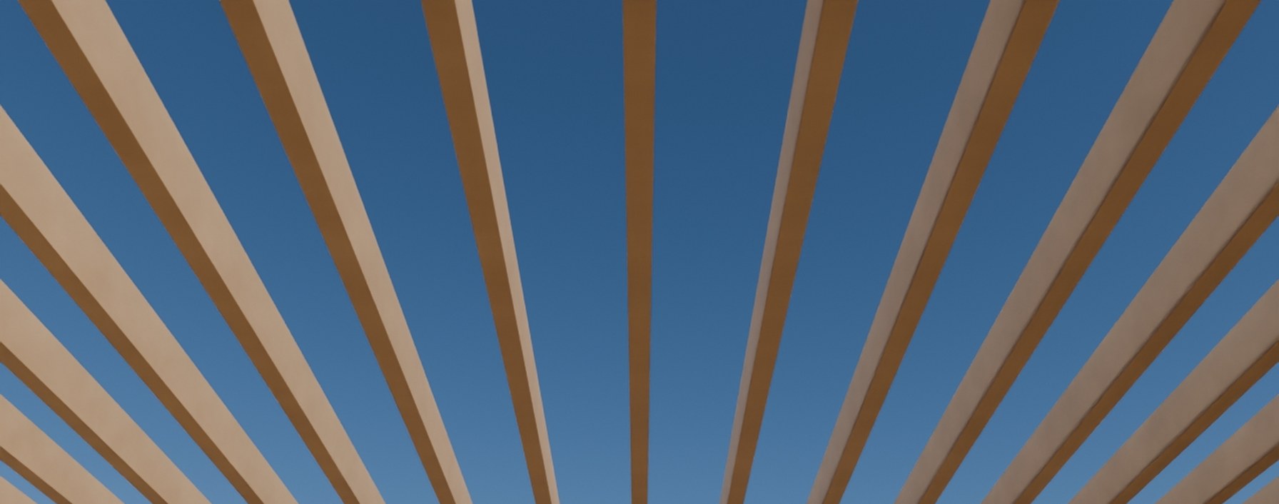 Cropped detail: dappled light through the pergola's rafter shadows.